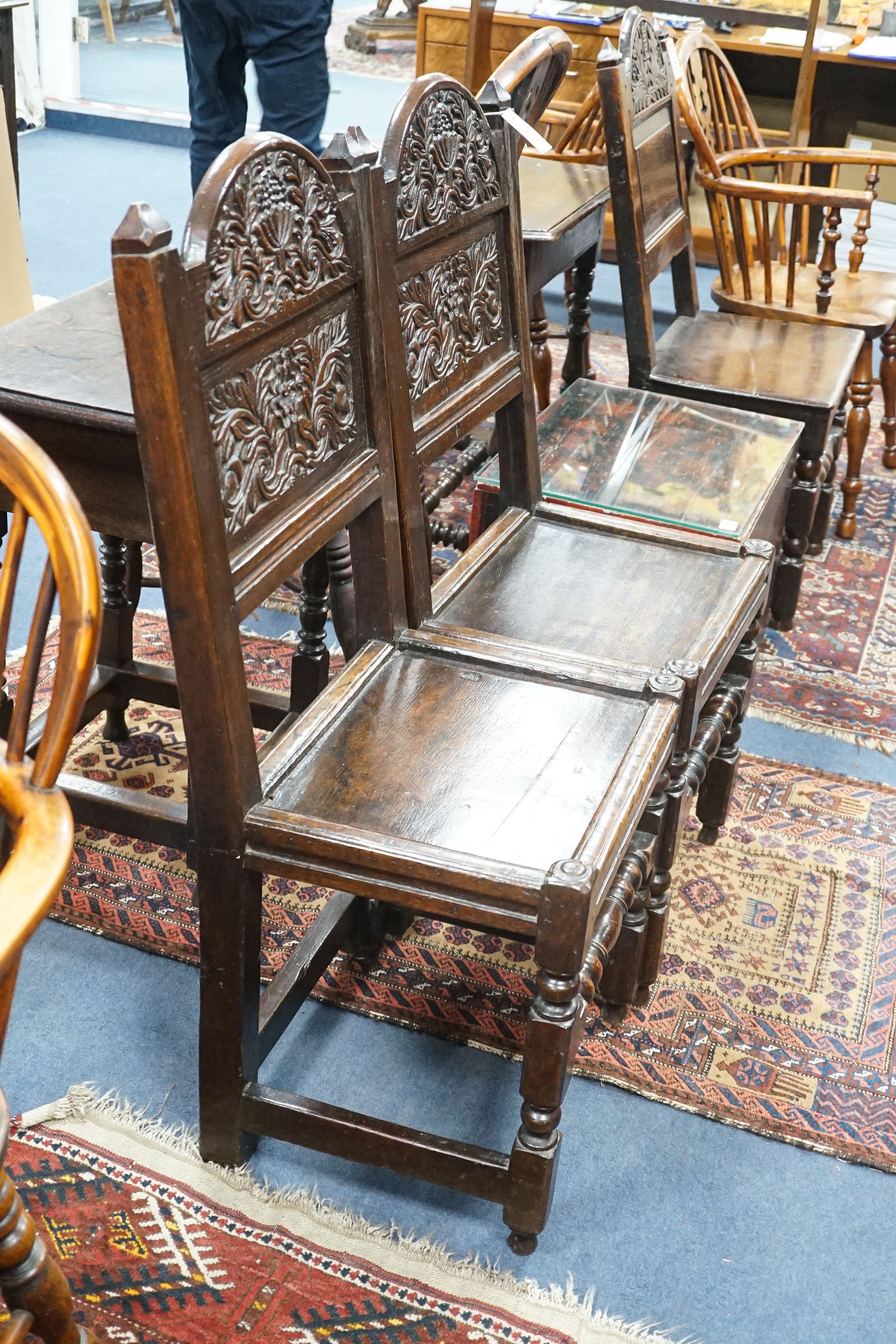 A pair of 17th century Lancashire carved oak side chairs, width 45cm, depth 39cm, height 101cm